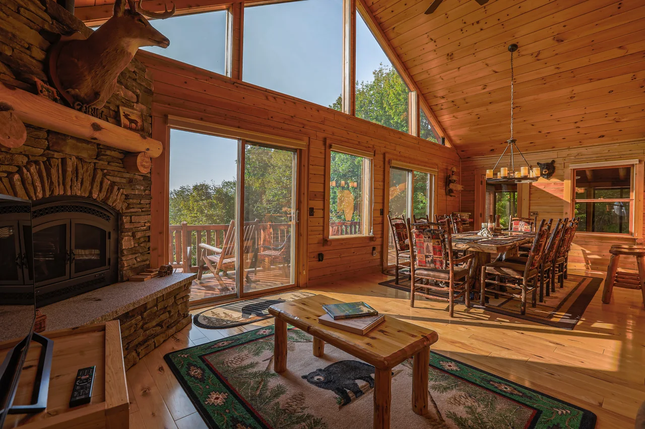The cabin’s dining table beneath vaulted timber ceilings